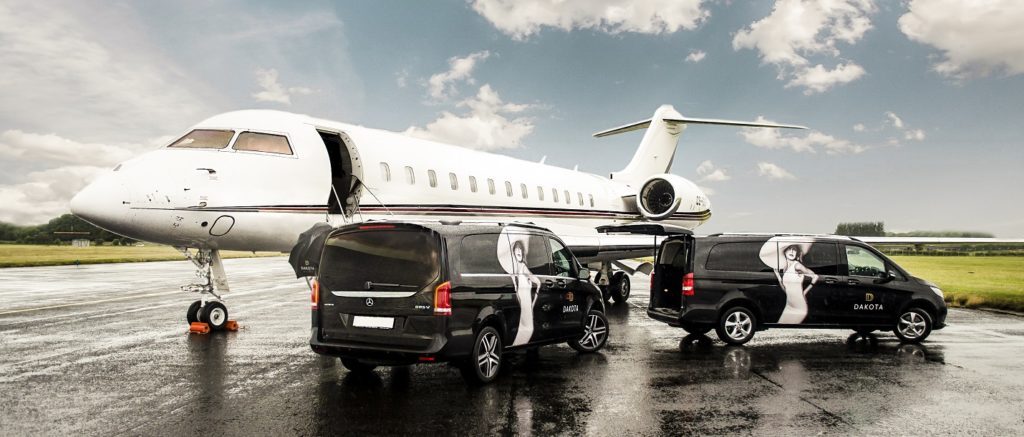 Private jet on runway with Dakota Hotel transport