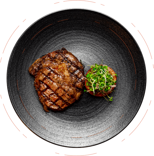 Simple grilled steak on a dark plate at the Dakota Glasgow